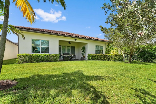 rear view of property with a lawn