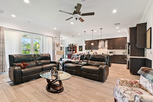 living room featuring crown molding and light hardwood / wood-style flooring