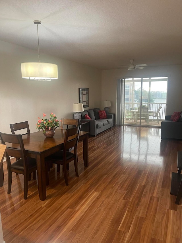 dining space with hardwood / wood-style floors, a textured ceiling, and ceiling fan