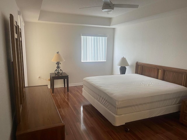 bedroom with dark hardwood / wood-style floors and ceiling fan