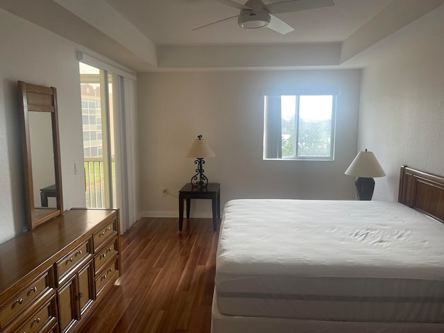 bedroom with dark hardwood / wood-style floors and ceiling fan