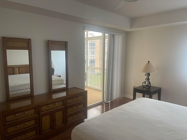 bedroom featuring dark wood-type flooring, access to outside, and ceiling fan