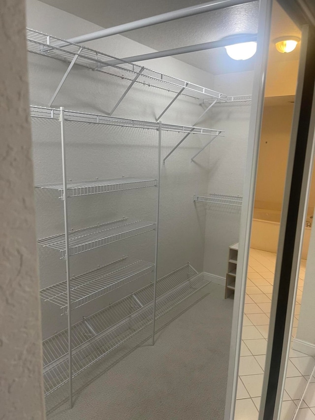 spacious closet featuring tile patterned flooring