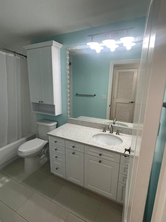 full bathroom with toilet, shower / tub combo with curtain, vanity, and tile patterned floors