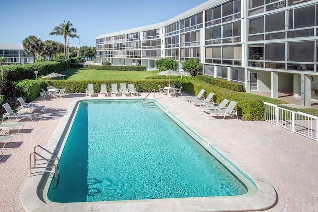 view of swimming pool with a yard and a patio area