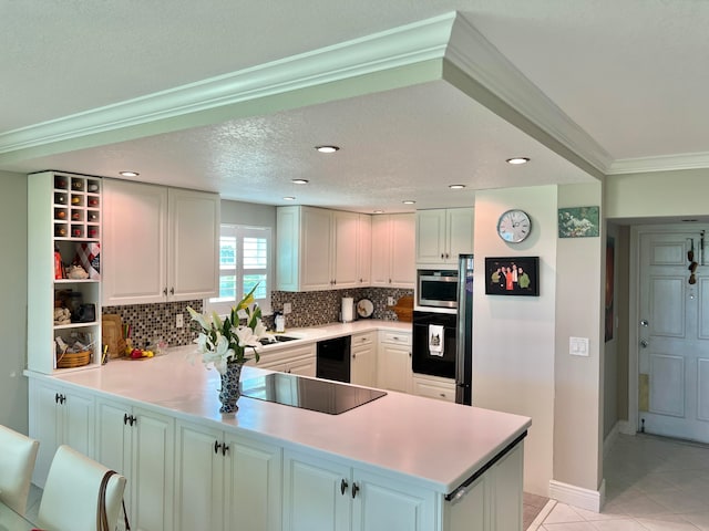 kitchen featuring black appliances, kitchen peninsula, wine cooler, and white cabinets