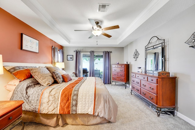 carpeted bedroom featuring ceiling fan, a raised ceiling, a textured ceiling, access to exterior, and ornamental molding