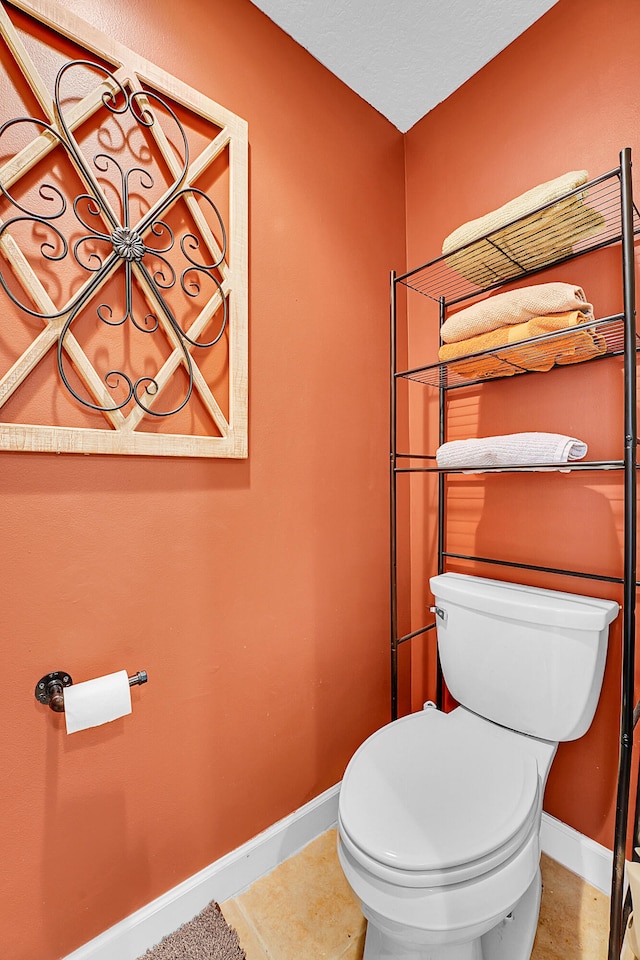 bathroom featuring tile floors and toilet