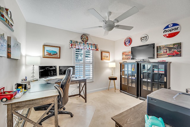 office area with light carpet, a textured ceiling, and ceiling fan