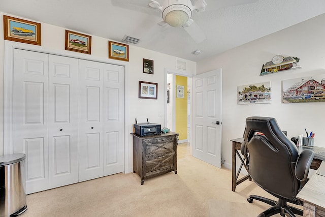 office with ceiling fan, a textured ceiling, and light colored carpet