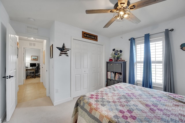 bedroom with light carpet, a closet, multiple windows, and ceiling fan