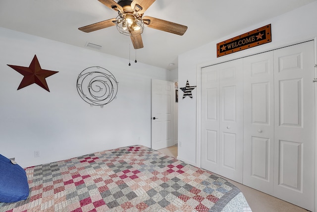 carpeted bedroom featuring ceiling fan and a closet