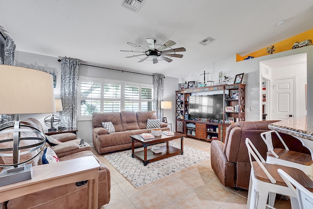 tiled living room with ceiling fan