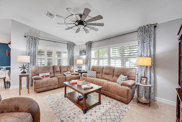 tiled living room featuring a textured ceiling and ceiling fan