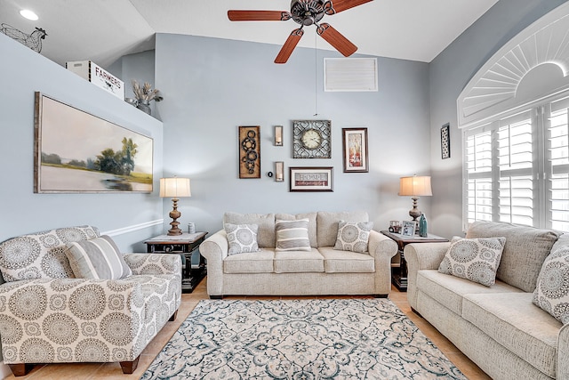 living room featuring hardwood / wood-style flooring, lofted ceiling, and ceiling fan