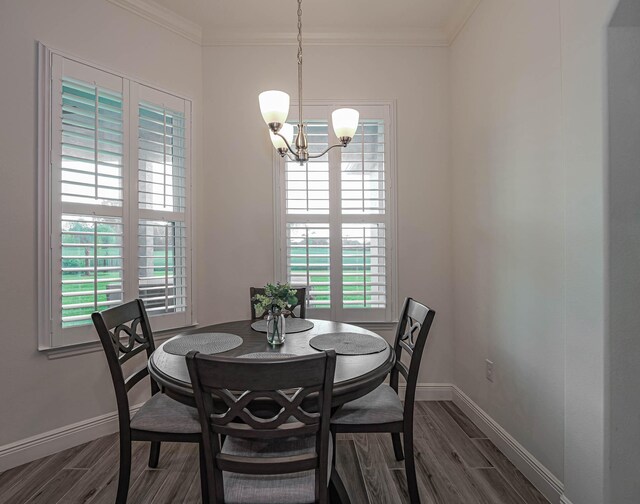 dining room with a healthy amount of sunlight, an inviting chandelier, and ornamental molding