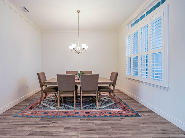 dining room with an inviting chandelier and ornamental molding