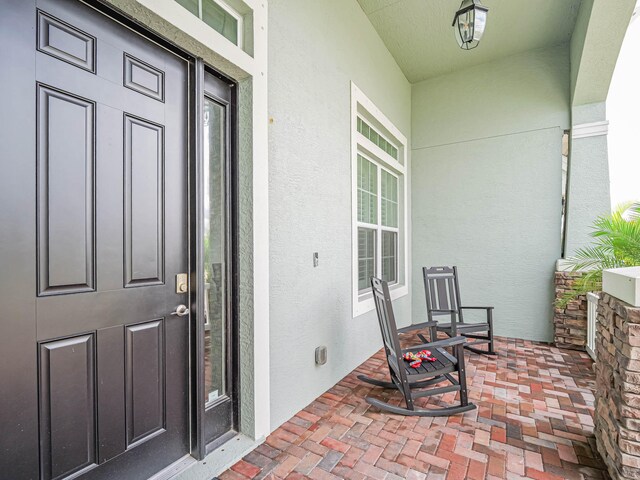 view of exterior entry featuring a porch