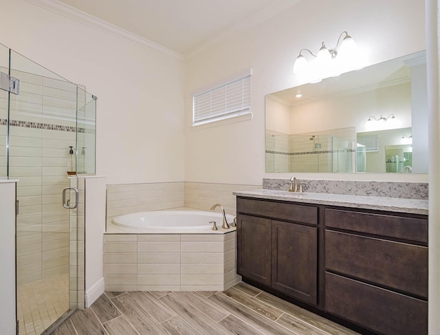 bathroom featuring independent shower and bath, crown molding, and vanity