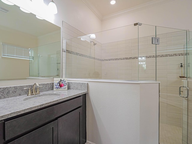 bathroom with crown molding, an enclosed shower, and vanity