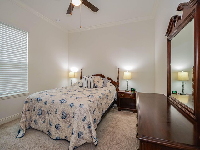 bedroom with ceiling fan, light colored carpet, and crown molding