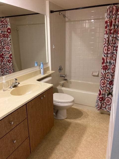 full bathroom with vanity, shower / tub combo, and toilet