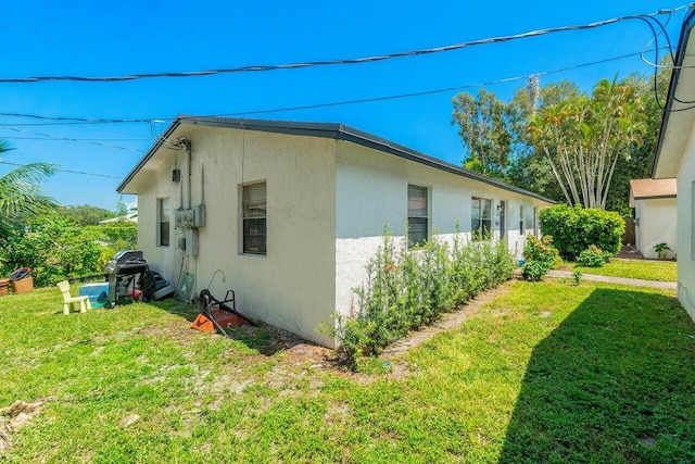 view of property exterior with a yard