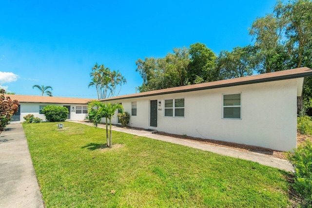 ranch-style home with a front lawn