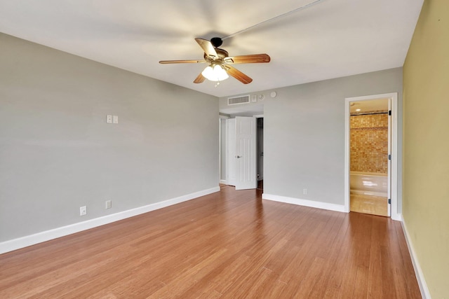 spare room featuring ceiling fan and light wood-type flooring