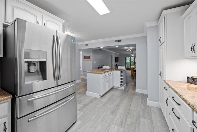 kitchen featuring stainless steel refrigerator with ice dispenser, white cabinetry, light hardwood / wood-style flooring, and light stone countertops