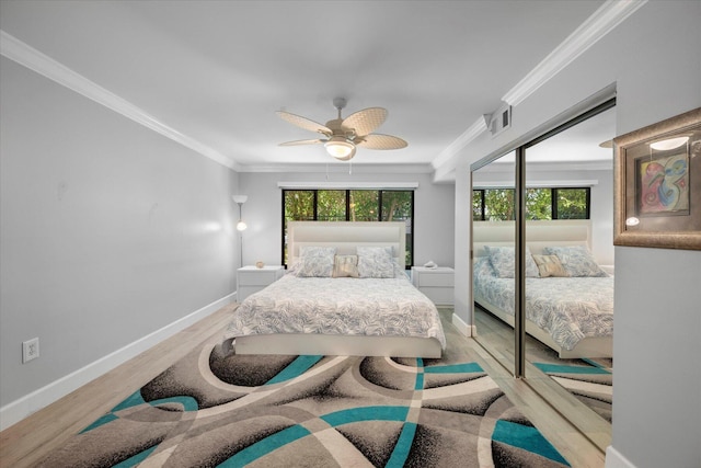 bedroom featuring multiple windows, ornamental molding, and wood finished floors