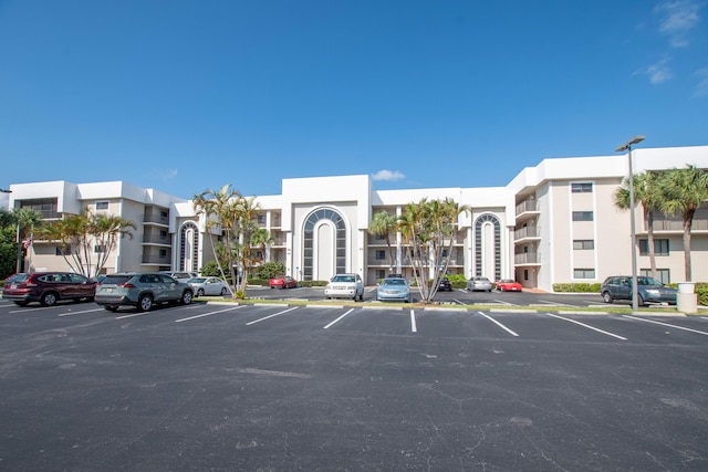 view of building exterior featuring uncovered parking