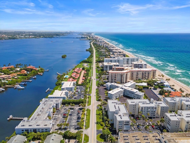 birds eye view of property featuring a view of city, a beach view, and a water view