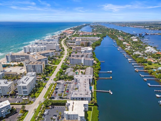 birds eye view of property featuring a water view and a city view