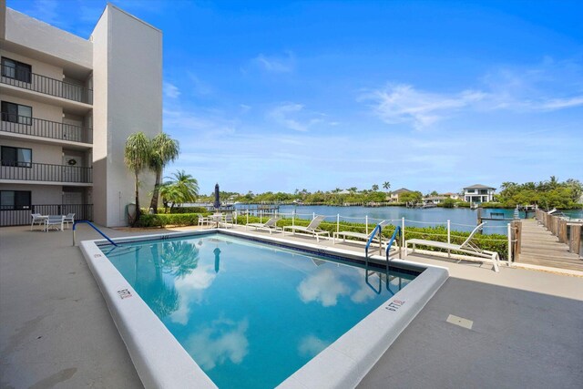 view of pool featuring a water view