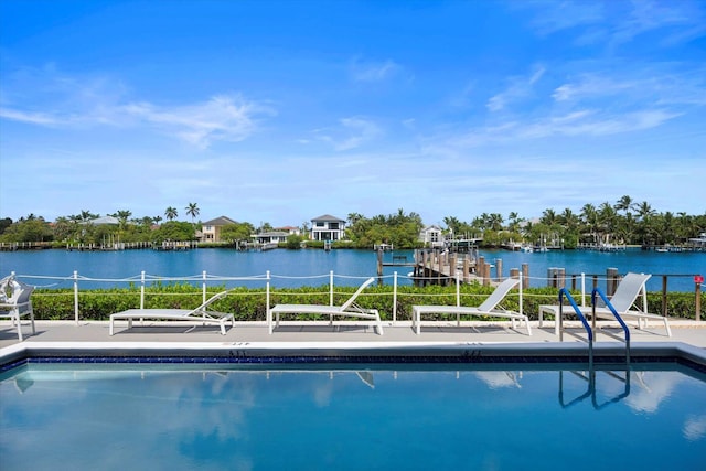 view of swimming pool featuring a water view