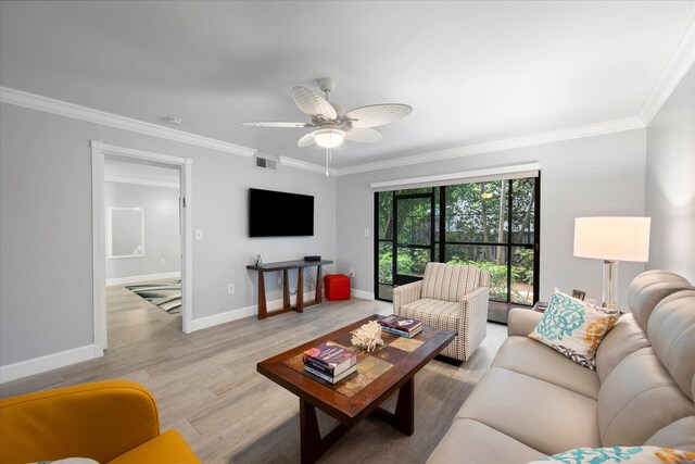 living room with wood-type flooring, ornamental molding, and ceiling fan