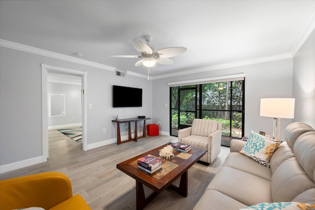 living room featuring ornamental molding, light wood-type flooring, visible vents, and baseboards