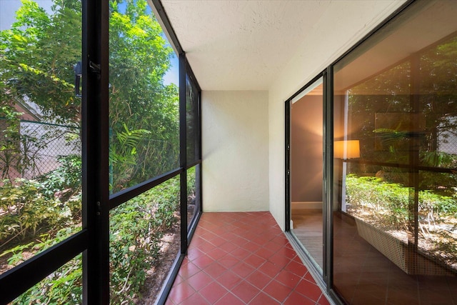 unfurnished sunroom featuring a wealth of natural light