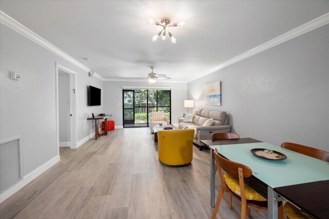 living room with ceiling fan, crown molding, and light wood-type flooring