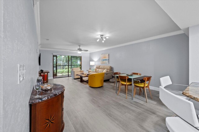 interior space featuring light hardwood / wood-style floors, ornamental molding, and ceiling fan