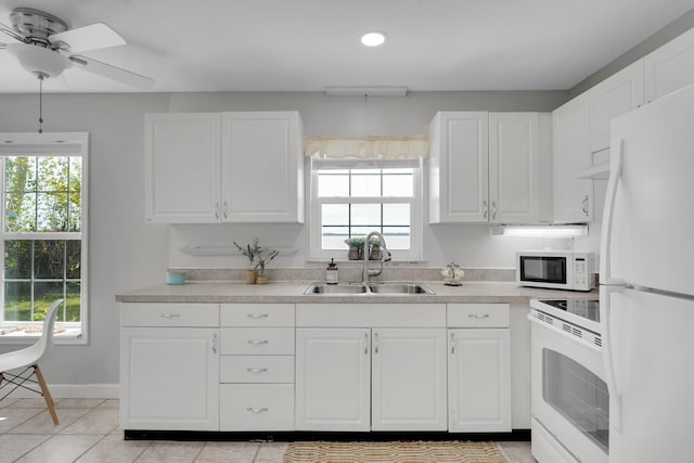 kitchen featuring white appliances, white cabinets, sink, ceiling fan, and light tile patterned flooring