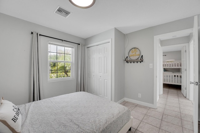 tiled bedroom with a closet