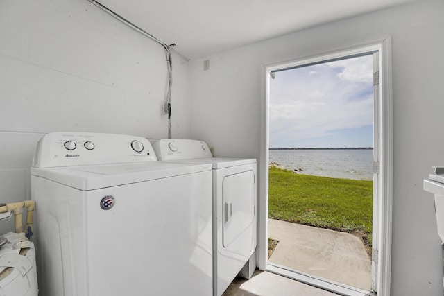 washroom featuring a water view and separate washer and dryer