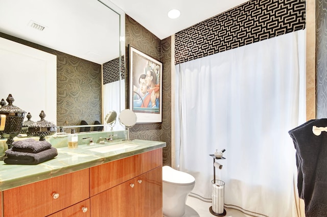 bathroom featuring vanity, a shower with shower curtain, and toilet