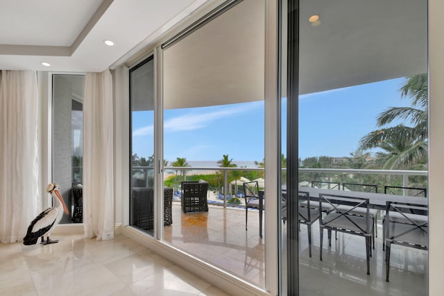 doorway to outside featuring expansive windows