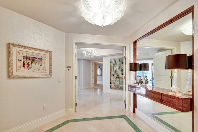 hallway featuring a notable chandelier