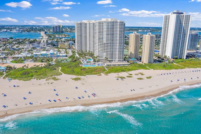 birds eye view of property with a water view and a view of the beach