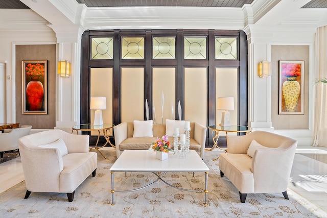 living room featuring ornate columns and ornamental molding