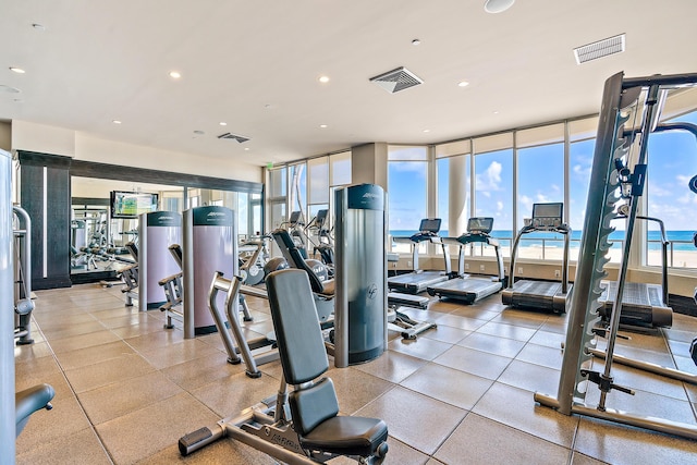 workout area with a water view and a wall of windows